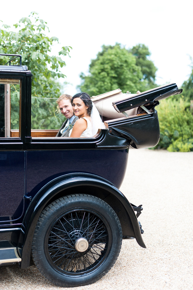 vintage black car with bride and groom