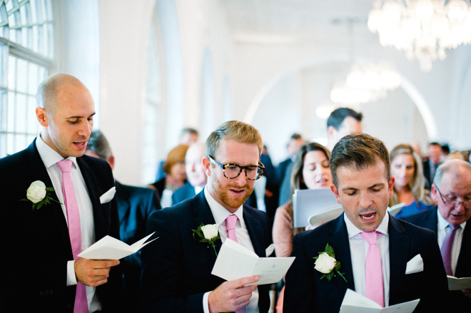 ushers in pink ties singing hymns at central london wedding