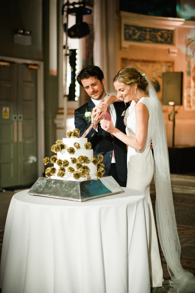 bride and groom cutting cake at one marylebone wedding